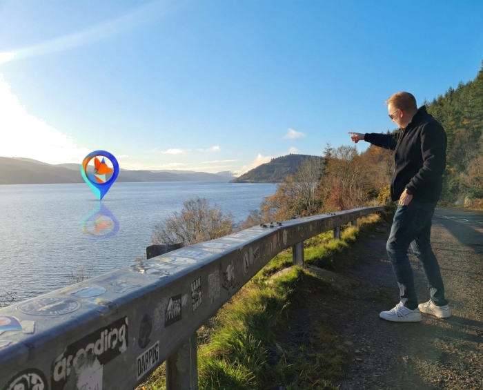 One of our Founders pointing dramatically out to a Corgi Couriers pin out in the middle of a body of water